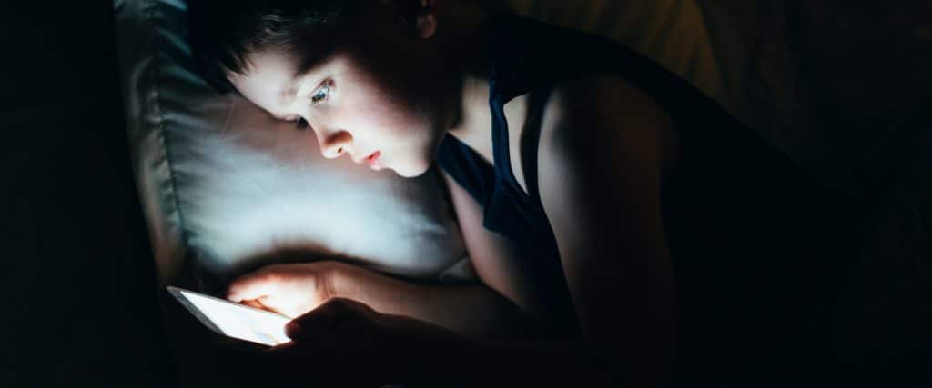 little boy on smartphone at night