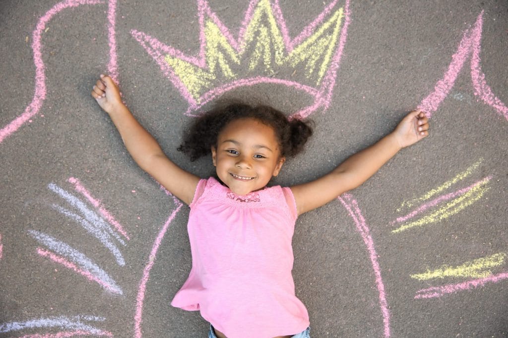 Girl having fun outside with chalk