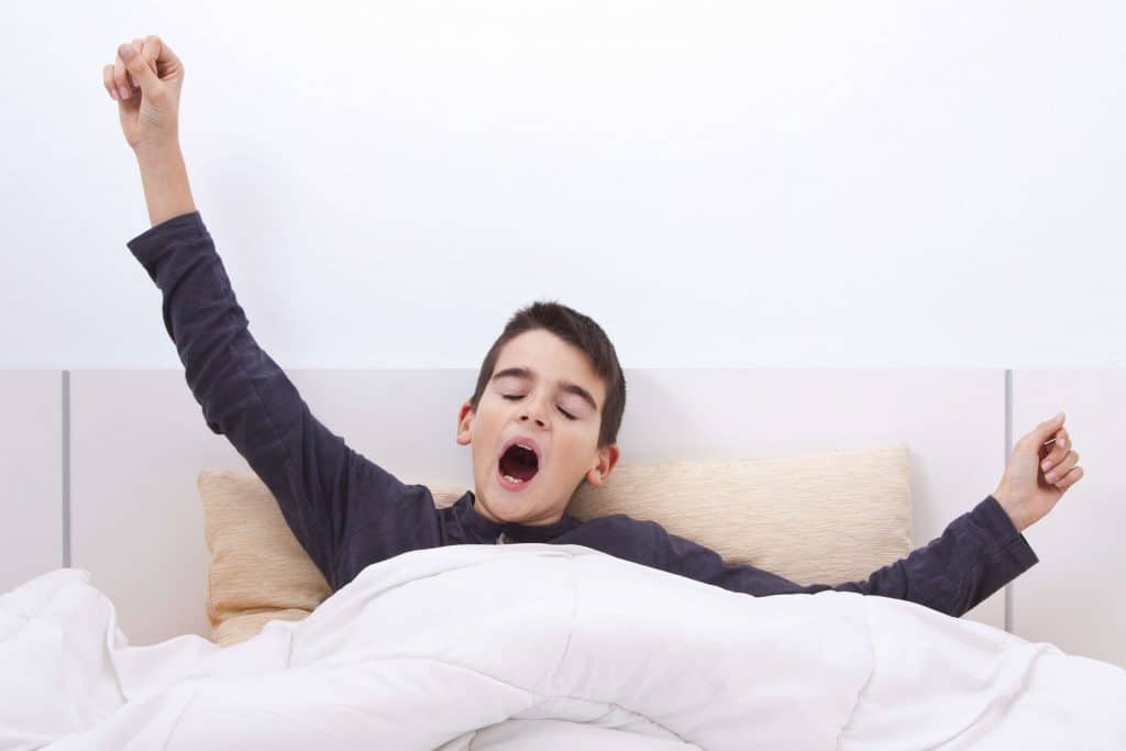 Kid yawning in bed