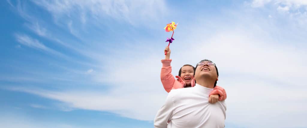 father and daughter looking at clouds