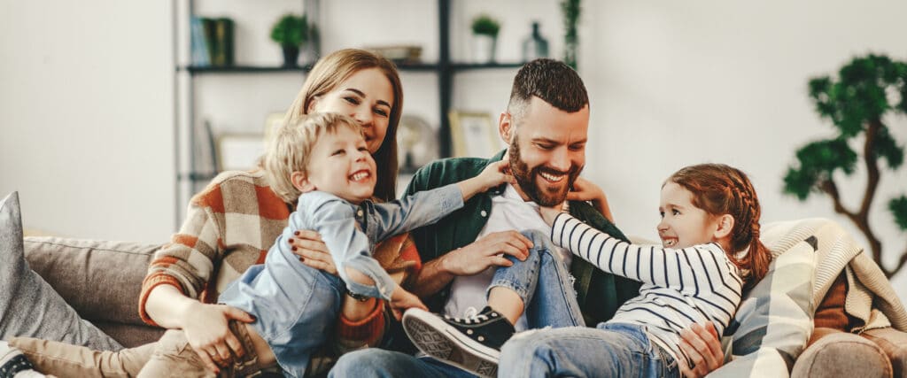 happy family mother father and kids at home on couch without screens