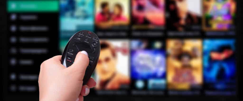 hand with remote watching netflix