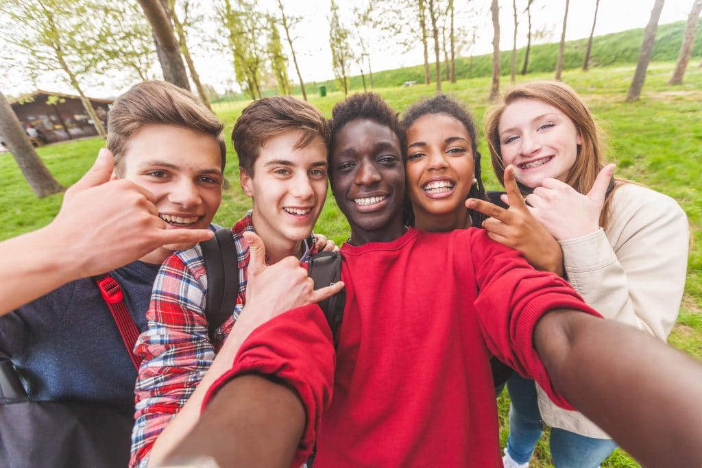 Teens taking a selfie outside