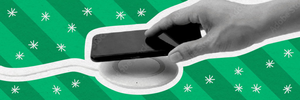 hand putting a phone on the charger with holiday background