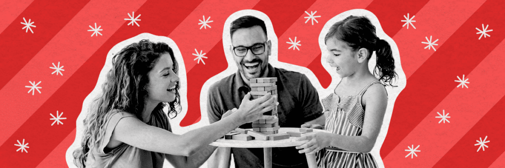 family laughing playing jenga with holiday background