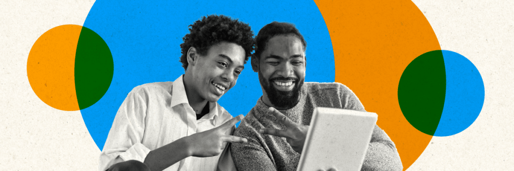 father and son smiling and doing peace signs at tablet