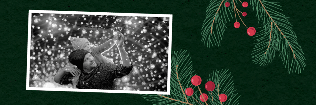 dad and daughter putting up Christmas lights