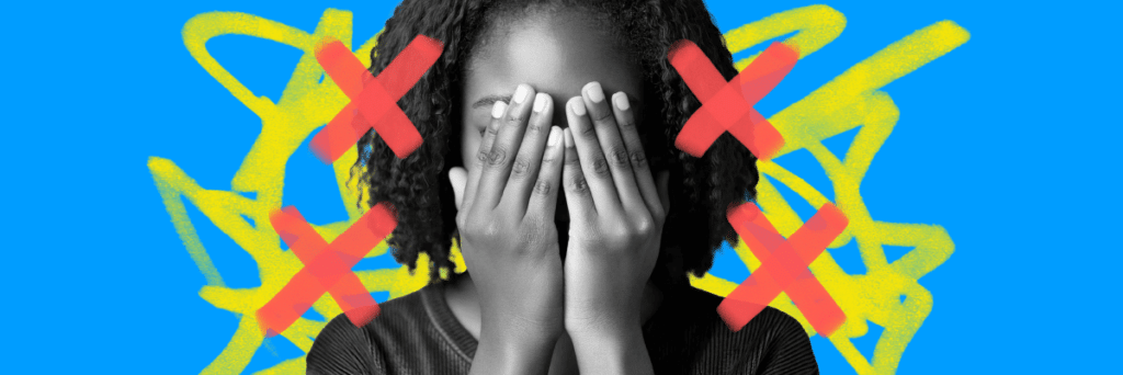 girl holding her hands over her face