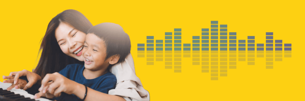 mom and young son smiling playing piano