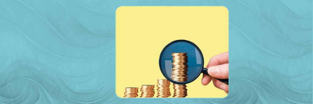 stacked coins under a magnifying glass