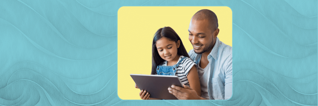 father and daughter looking at a tablet together