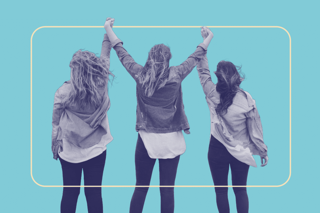 3 girls raising their arms victoriously