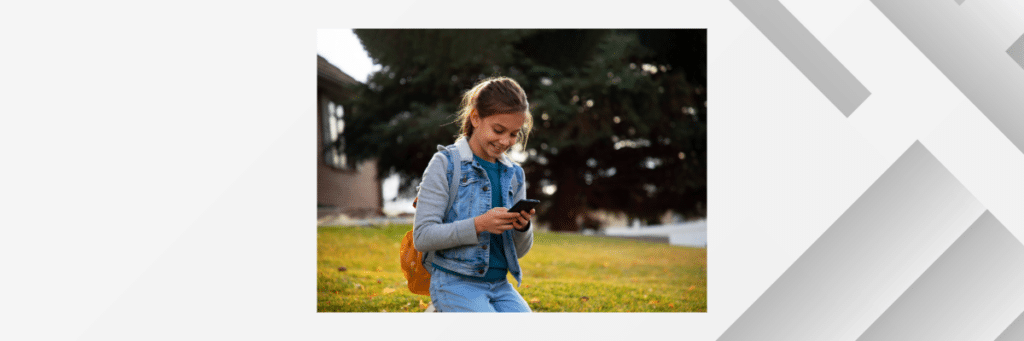 little girl smiling at cellphone