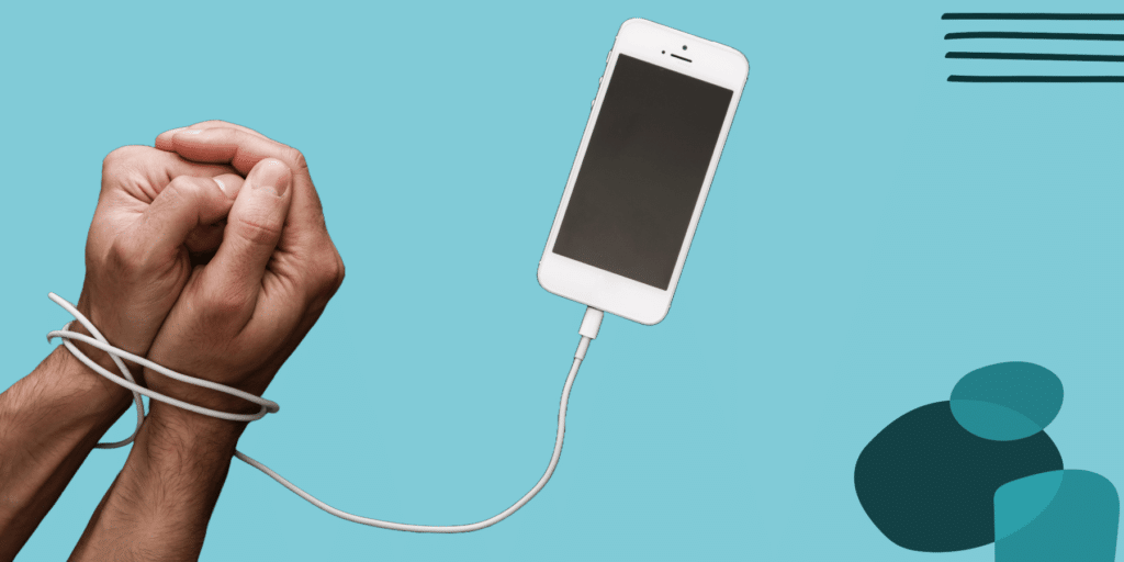 cell phone with chord wrapped around wrists like handcuffs