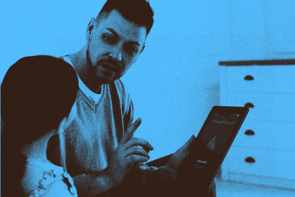 Photo of a dad talking to his daughter about parental controls on the ipad with a blue static filter
