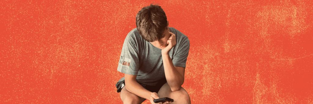 teen boy looking at cellphone