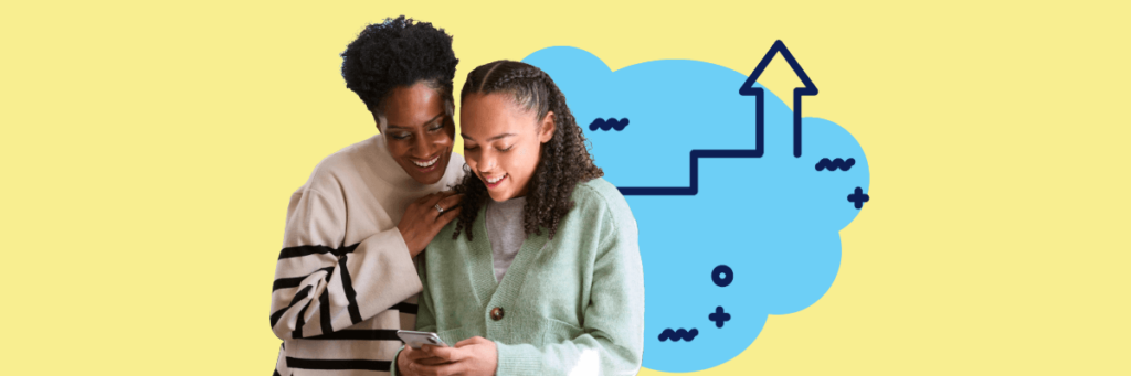 mother and daughter smiling looking at cellphone smiling