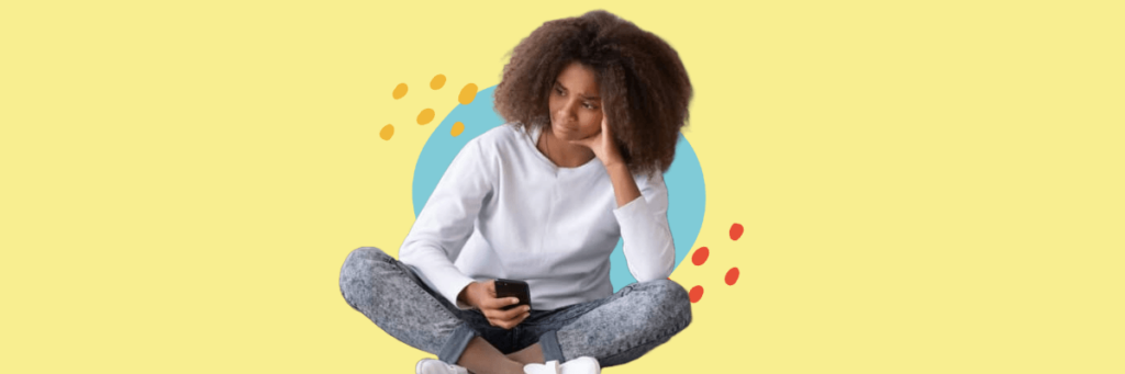 sad teen looking away from her cell phone