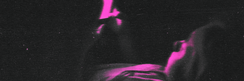 kid sitting in the dark looking at cell phone screen