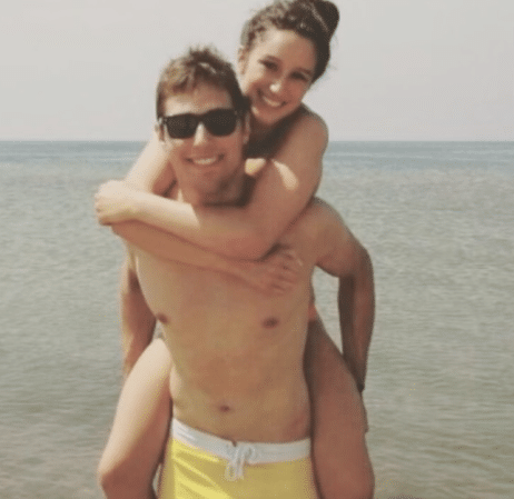 photo of austin weirich giving piggy back ride at beach