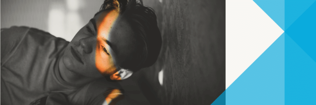 teen boy with sunshine over part of his face