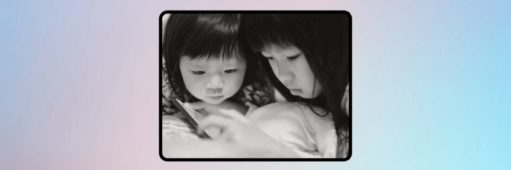 two little girls looking at a tablet
