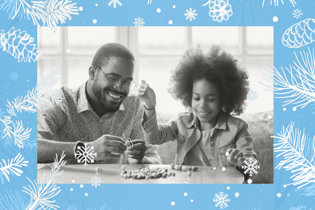Black dad and daughter crafting beaded necklaces together with a blue snowflake border