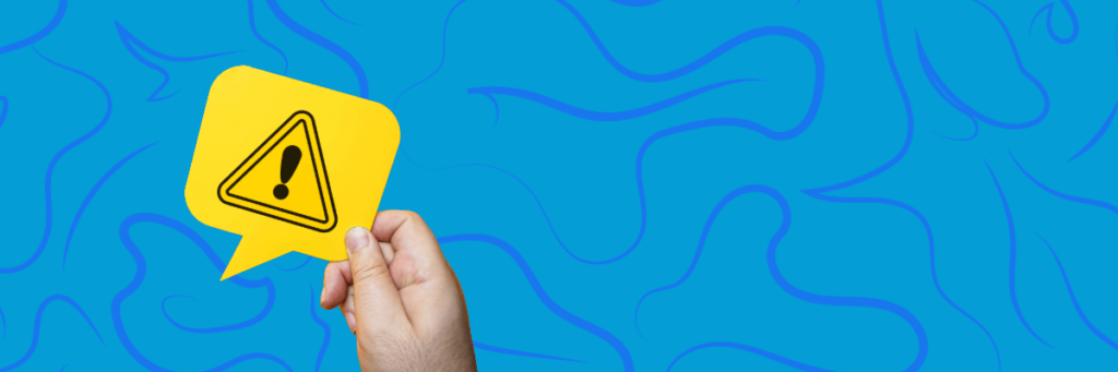 hand holding up a warning sign