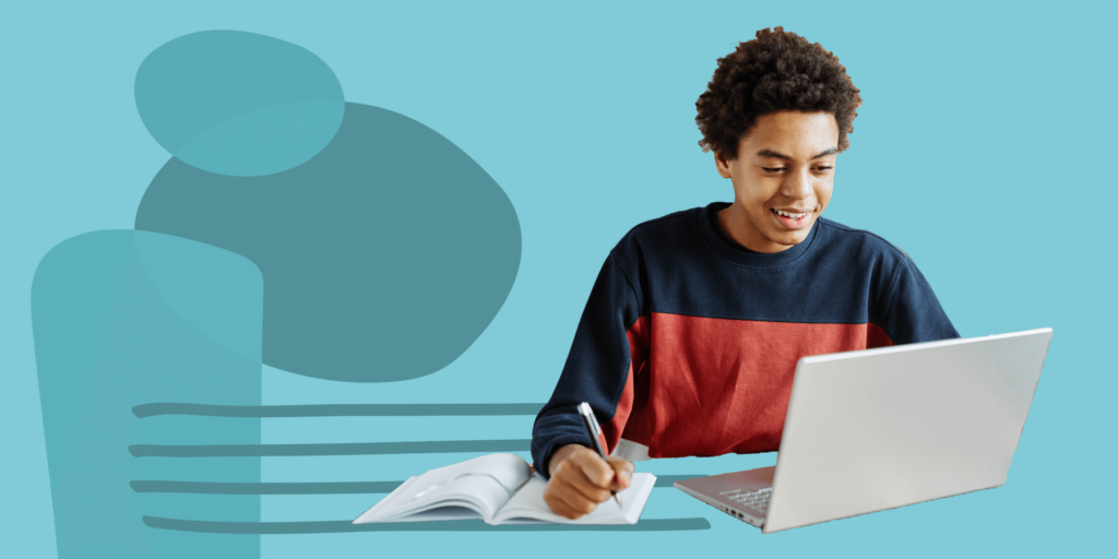 teen boy doing homework on his laptop